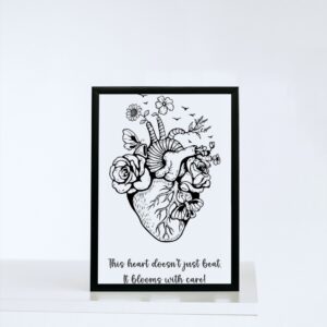 A black-and-white anatomical heart illustration filled with blooming flowers, butterflies, and birds, paired with the quote: “This heart doesn’t just beat. It blooms with care!”