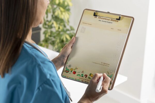 Personalized dental prescription pad with fun tooth illustrations, patient details section, and Dr. Khushboo Mishra’s name printed at the top.