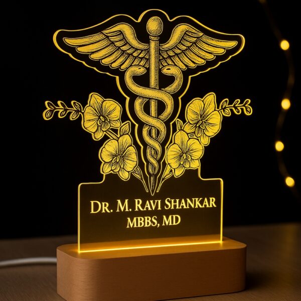 Custom LED night lamp with an engraved Caduceus medical symbol and floral accents, glowing warmly with the name “Dr. M. Ravi Shankar – MBBS, MD” on a wooden base, placed outdoors at dusk.