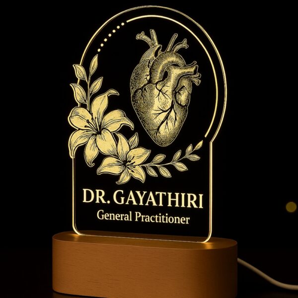 LED night lamp with a detailed anatomical heart and floral design, engraved with “Dr. Gayathiri – General Practitioner,” glowing on a wooden base in a clinic setting.