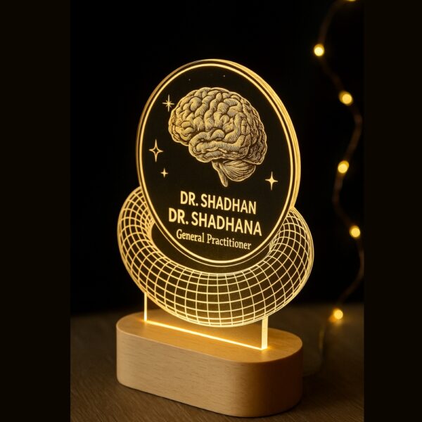 Custom LED night lamp with an engraved brain design and the text “SG. Clinic – Dr. Shadhana, General Practitioner” glowing on a wooden base, placed on a doctor’s desk.