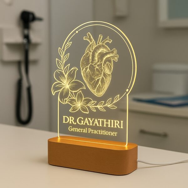 LED night lamp with a detailed anatomical heart and floral design, engraved with “Dr. Gayathiri – General Practitioner,” glowing on a wooden base in a clinic setting.