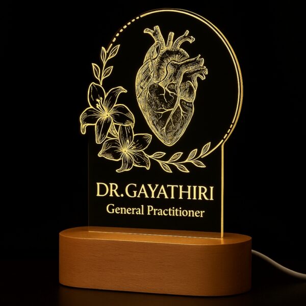 LED night lamp with a detailed anatomical heart and floral design, engraved with “Dr. Gayathiri – General Practitioner,” glowing on a wooden base in a clinic setting.