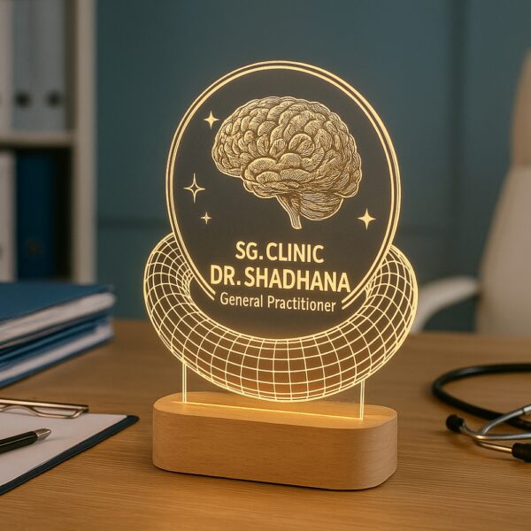 Custom LED night lamp with an engraved brain design and the text “SG. Clinic – Dr. Shadhana, General Practitioner” glowing on a wooden base, placed on a doctor’s desk.