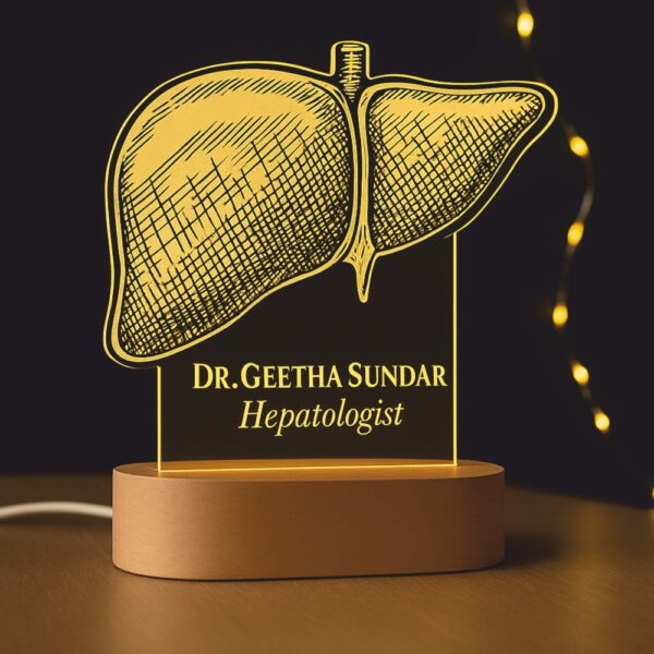 Custom LED night lamp with a detailed anatomical liver engraving, personalized with the name “Dr. Geetha Sundar – Hepatologist,” displayed on a wooden base in a hospital corridor.
