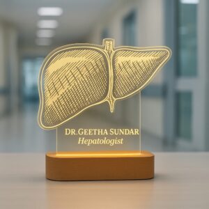 Custom LED night lamp with a detailed anatomical liver engraving, personalized with the name “Dr. Geetha Sundar – Hepatologist,” displayed on a wooden base in a hospital corridor.