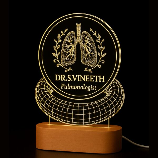 Personalized LED night lamp featuring an anatomical lung illustration, floral wreath, and the name “Dr. S. Vineeth – Pulmonologist,” glowing on a wooden base in a clinic setting.