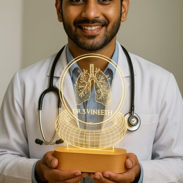 Personalized LED night lamp featuring an anatomical lung illustration, floral wreath, and the name “Dr. S. Vineeth – Pulmonologist,” glowing on a wooden base in a clinic setting.