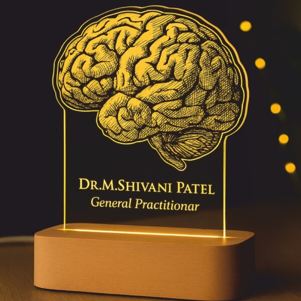 Personalized LED night lamp featuring a detailed brain illustration with the name “Dr. M. Shivani Patel – General Practitioner,” glowing warmly on a wooden base placed on a doctor’s desk.