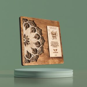 Intricately carved wooden plaque with mandala design and engraved appreciation message for medical camp contribution.