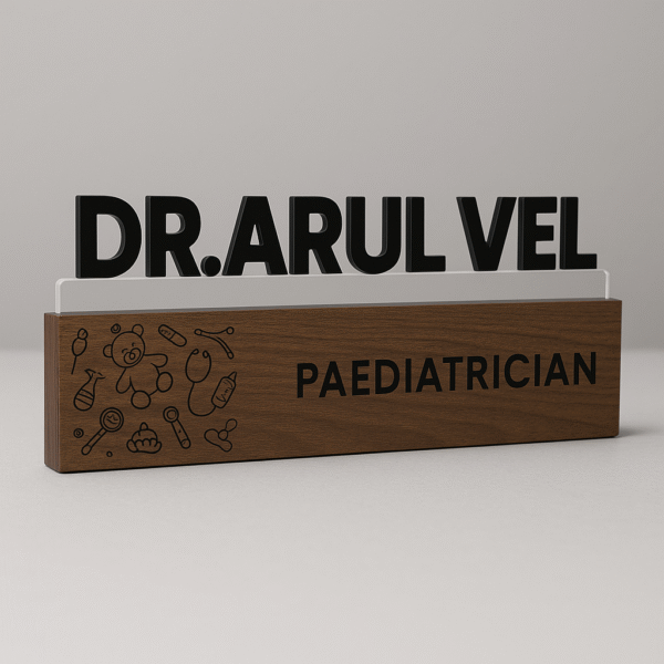 Customized pediatrician desk name plate with baby icons, wooden finish, and acrylic lettering for clinic table