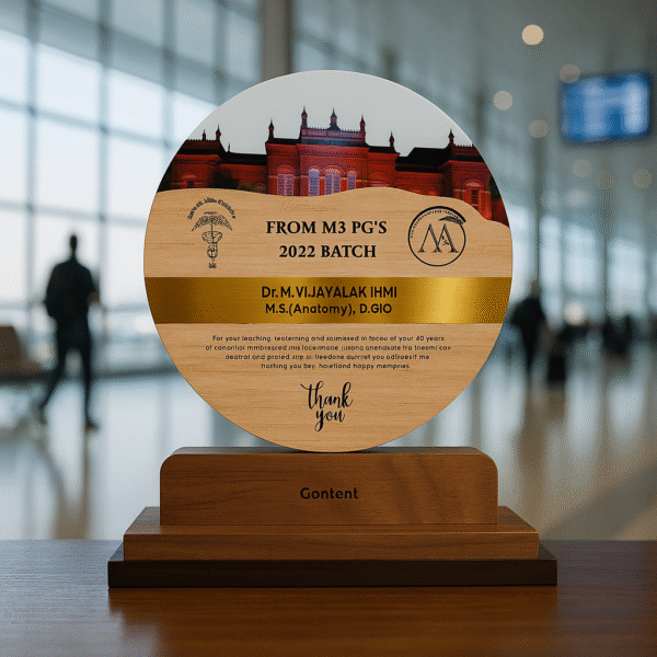 Round wooden doctor memento with medical college building photo, engraved thank-you message, and golden name band on a bookshelf.