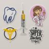 Set of 5 vinyl doctor-themed stickers including a cartoon doctor, syringe, molar tooth, Caduceus symbol, and “Super Doctor” quote — perfect for laptops and bottles.