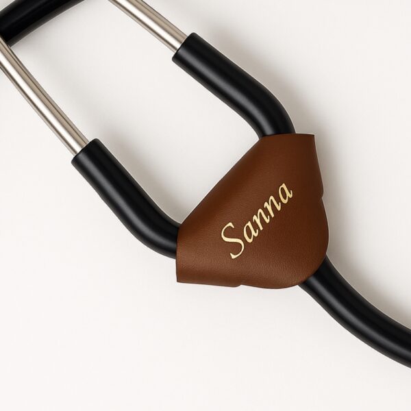 Dark brown leather stethoscope name tag with engraved name "Sanna" in golden finish