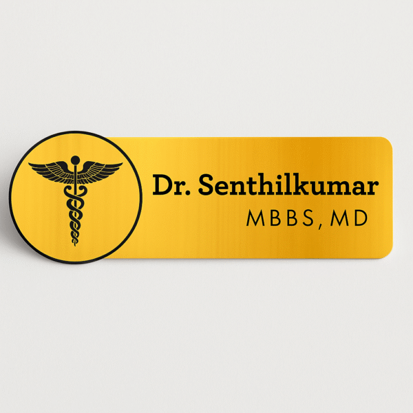 Gold-finish doctor name badge with black caduceus symbol and custom name and degree text for MBBS, MD
