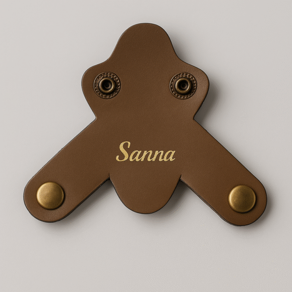 Dark brown leather stethoscope name tag with engraved name "Sanna" in golden finish