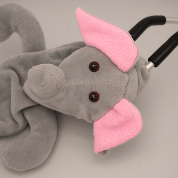 Elephant-themed grey stethoscope skin with pink ears wrapped around a stethoscope on a plain background.