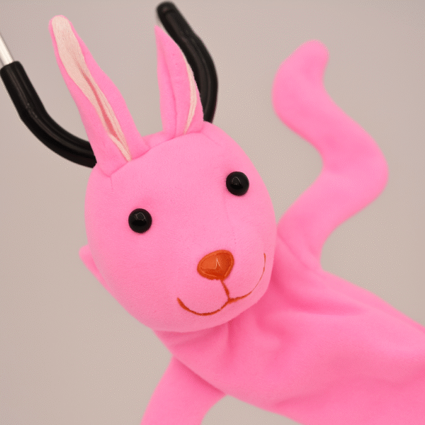 Pink bunny-themed stethoscope skin with floppy arms and long ears wrapped around a stethoscope on a plain background.