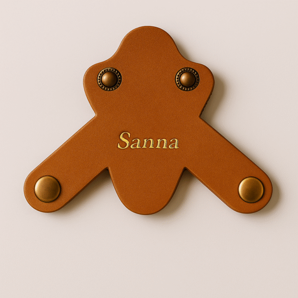 Tan brown leather stethoscope name tag with engraved name "Sanna" in glossy gold finish